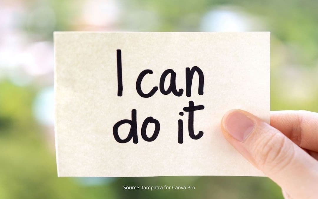 Hand holding a scrap of paper with "I can do it" written on it, to illustrate how to embrace change.
