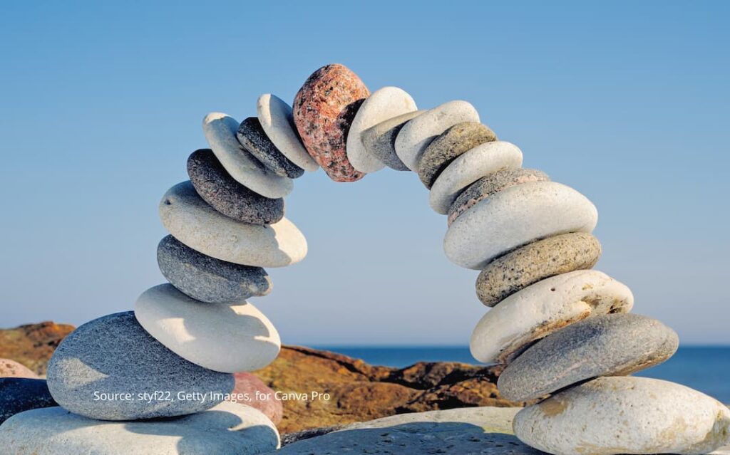 Rocks balanced in a semicircle to represent weighing your cultural lens when making decisions.