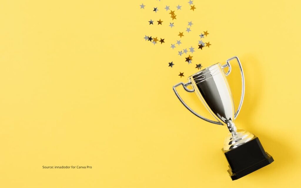 Image of a trophy with confetti exploding from it to illustrate the arrival fallacy.