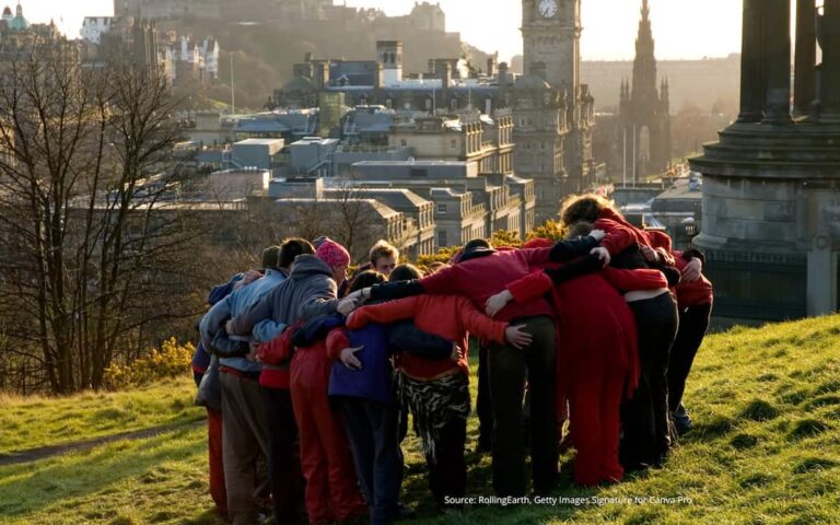A group of people with their arms around each other to illustrate a blog post about nurturing a sense of belonging.
